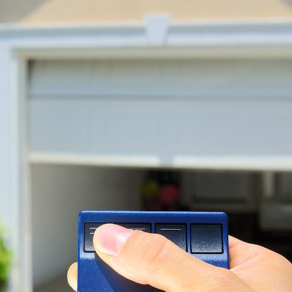 Garage door Repair page image Person opening a garage door with a remote